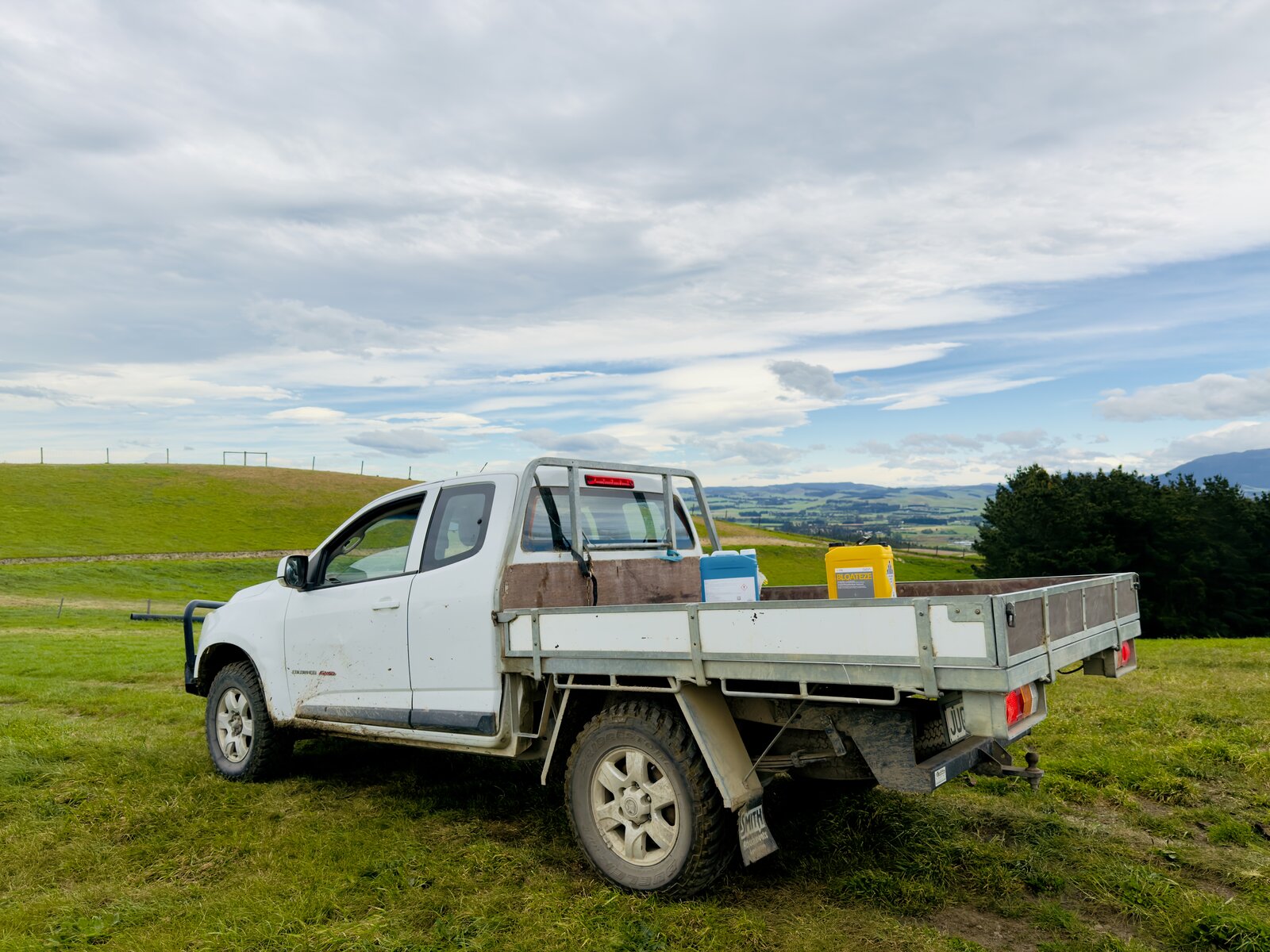 A farm ute parked on a Canterbury hillside overlooking the valley